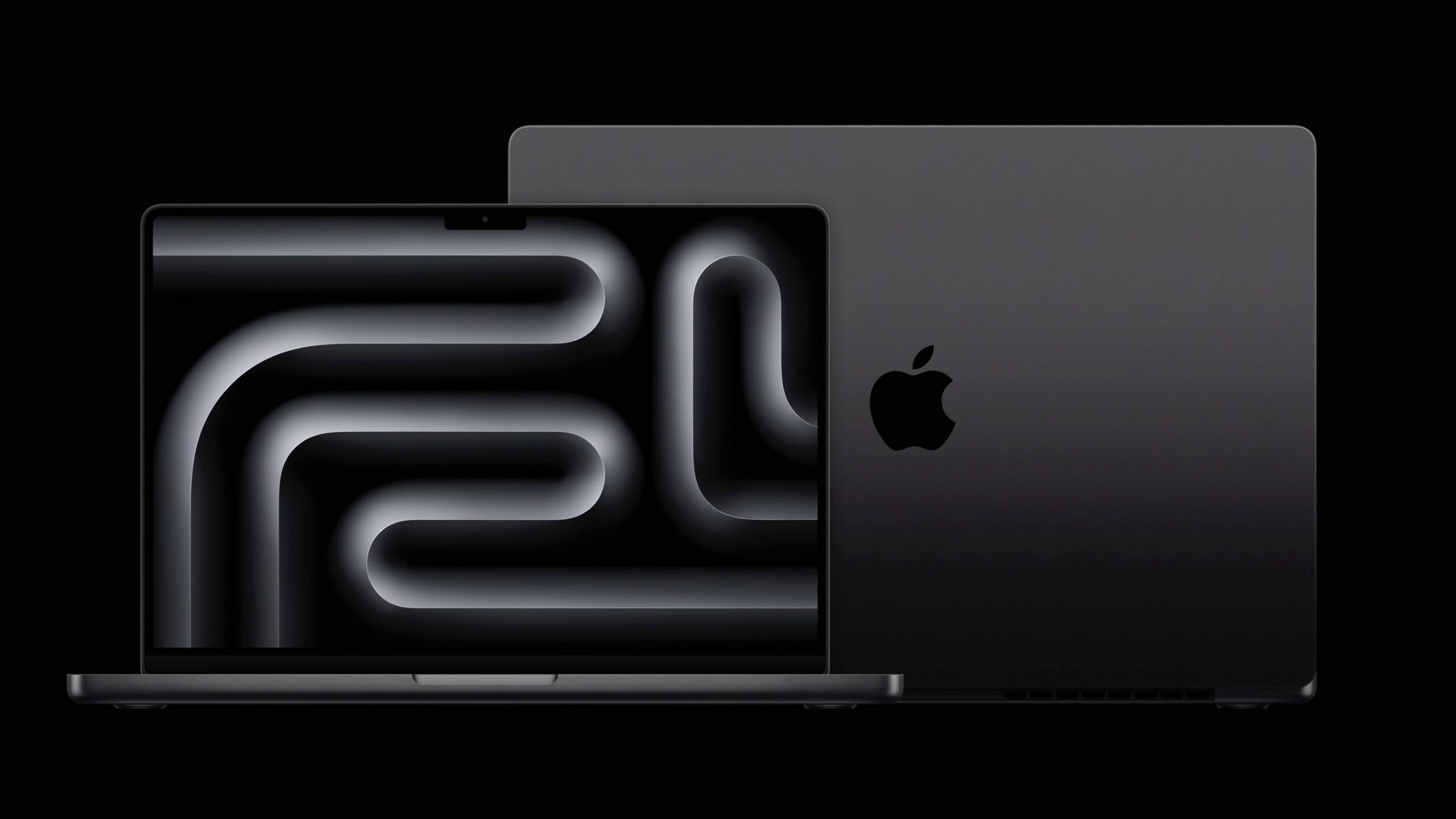 Apple 14" MacBook Pro von vorn, dahinter Rückseite des 16" MacBook Pro. Beide in Space Schwarz.